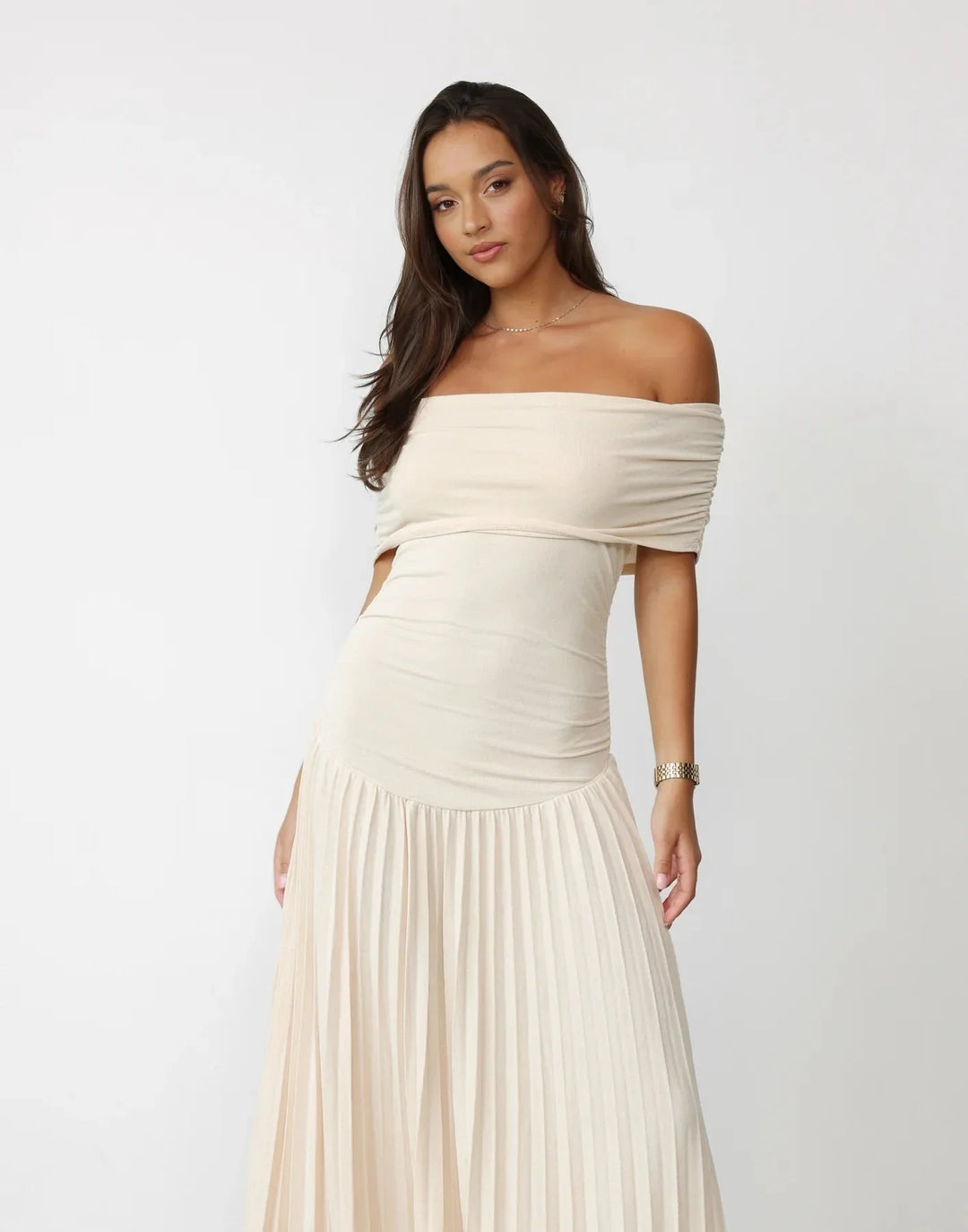 Cream off-shoulder summer maxi dress, flowy and pleated skirt detail.
