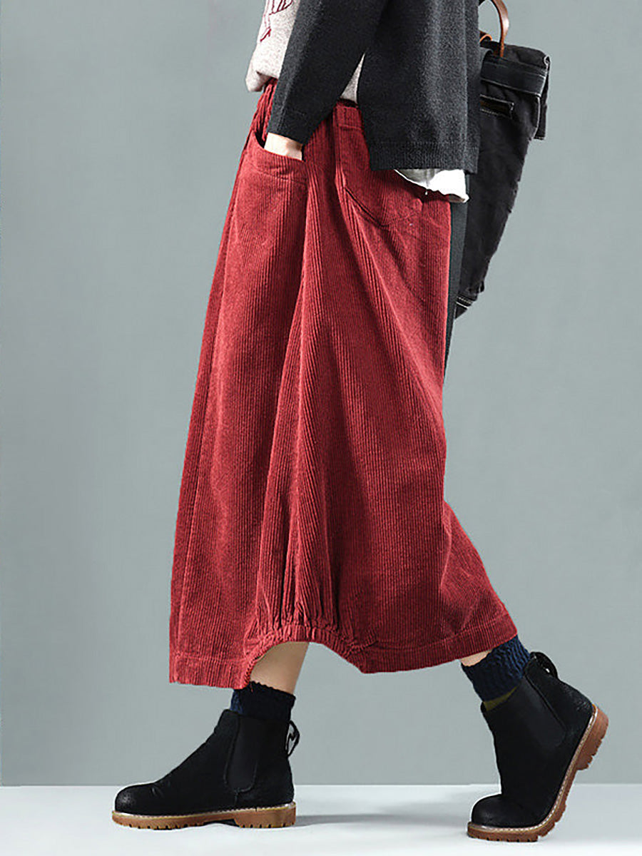 Red women's pleated maxi skirt with a loose, flowy fit, front buttons, and practical side pockets.