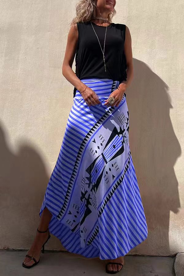 Full length view of a women's long pleated maxi skirt, showcasing its elegant flowy tiered design.