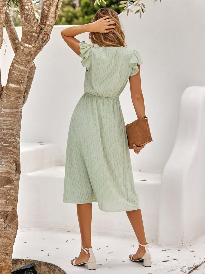 Sophisticated women's midi dress, perfect for warm weather with a flowy V-neck and elegant ruffled details.