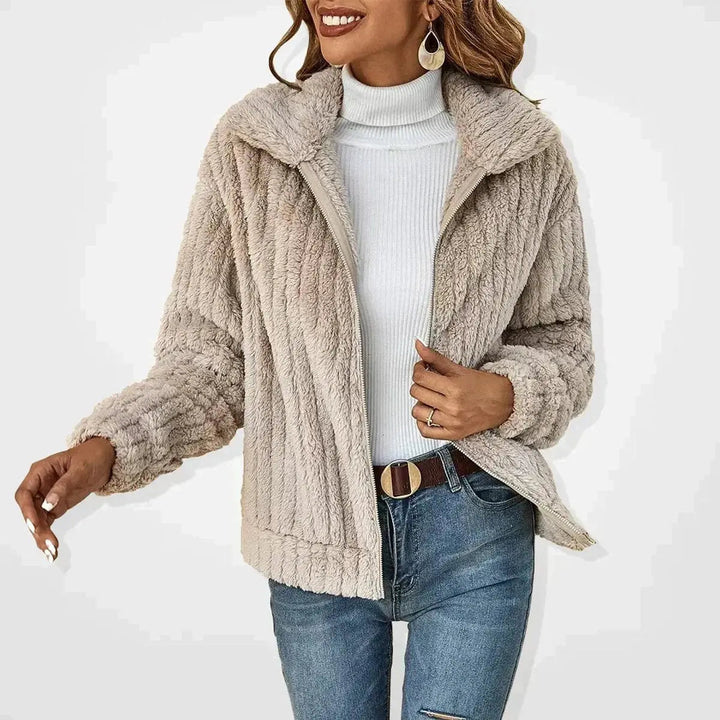Women's fluffy zip-up quilted jacket in a warm winter style. Perfect cozy outerwear for cold weather.