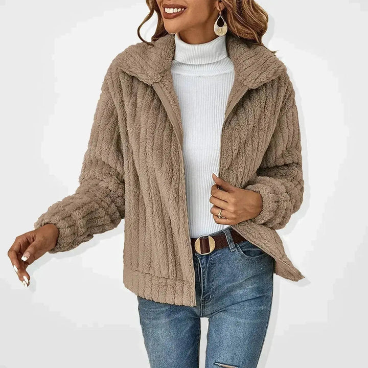 Casual women's quilted jacket with a fluffy texture and zip-up design. Great layering piece for autumn.