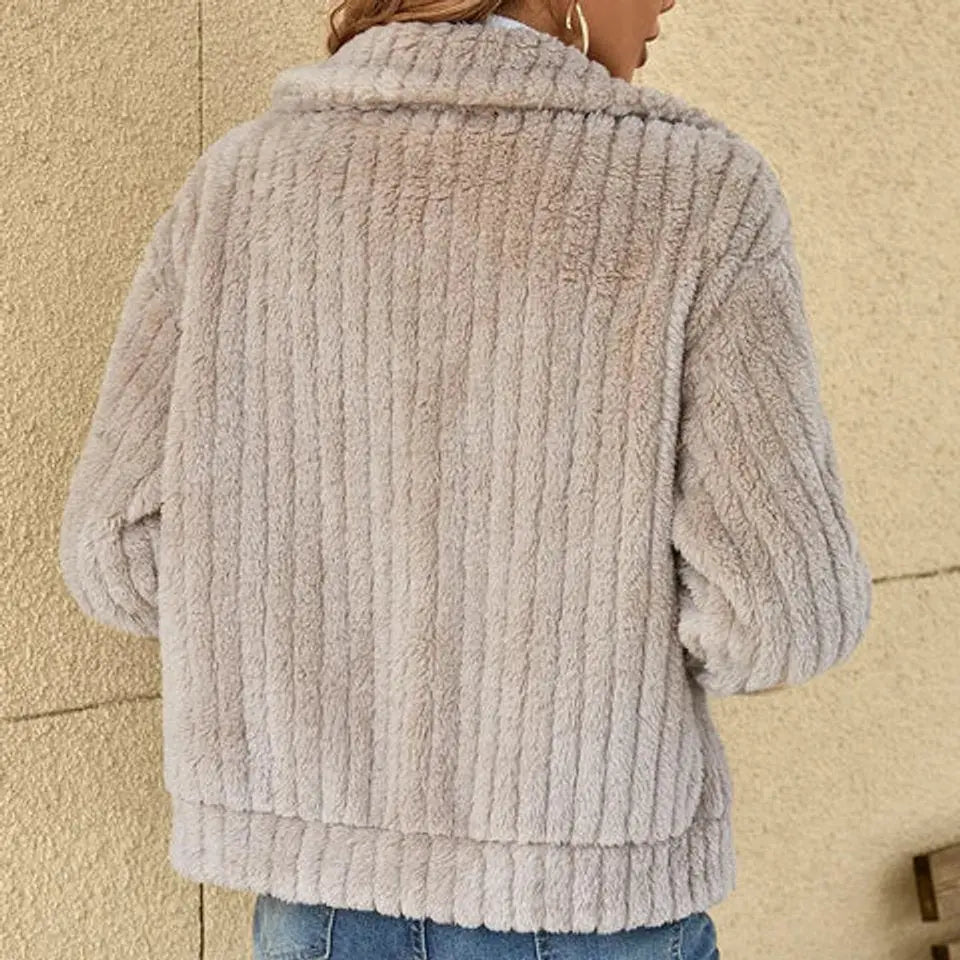 Plush women's warm fluffy quilted winter jacket. A comfortable zip-up outerwear coat for chilly days.