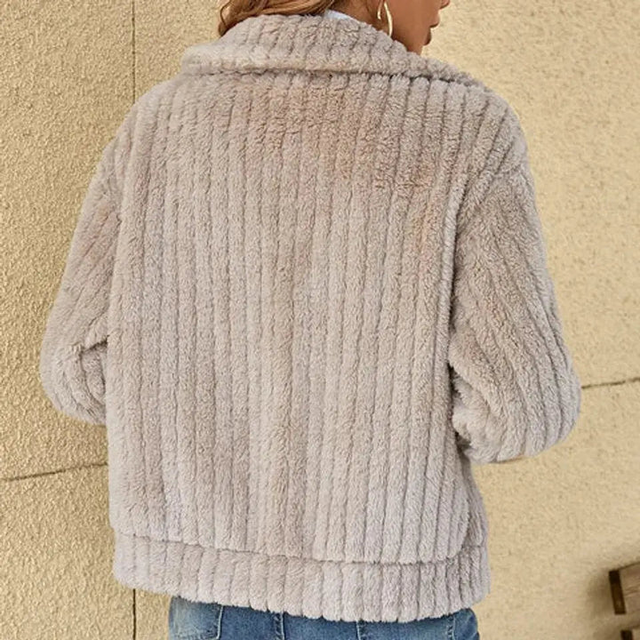 Plush women's warm fluffy quilted winter jacket. A comfortable zip-up outerwear coat for chilly days.