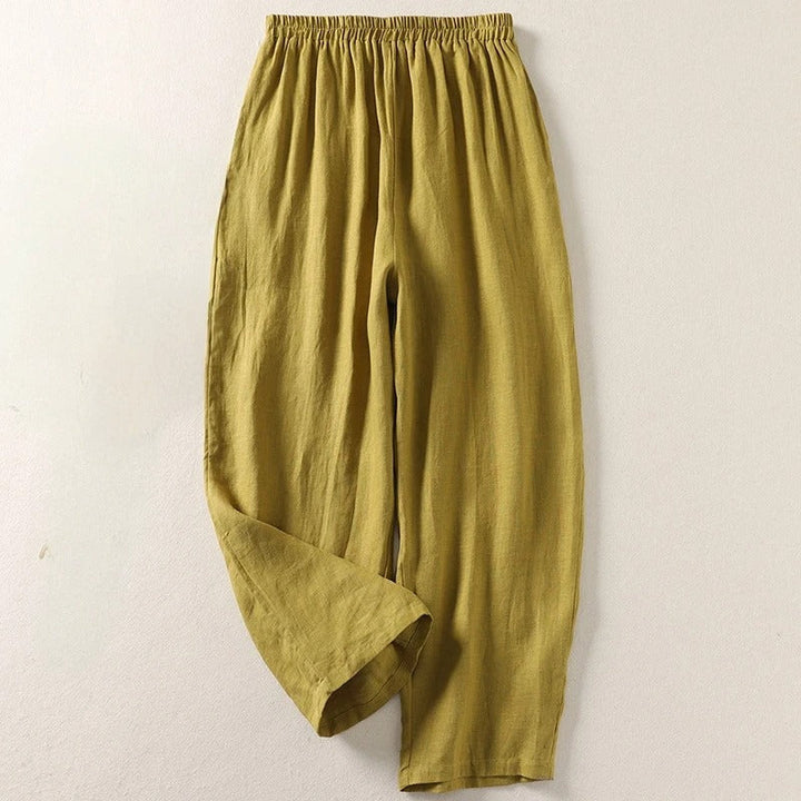 Woman wearing fluid cotton blend wide-leg trousers, showcasing their relaxed fit and elegant drape.