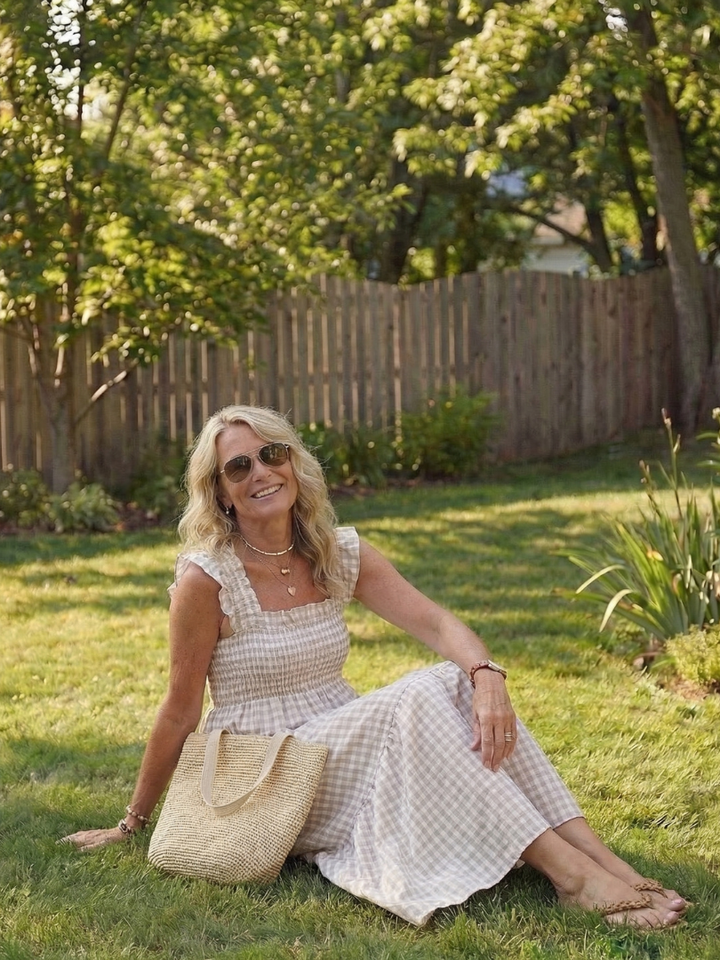 Comfortable women's smocked gingham maxi dress featuring flutter sleeves, a relaxed fit, and pull-on style.