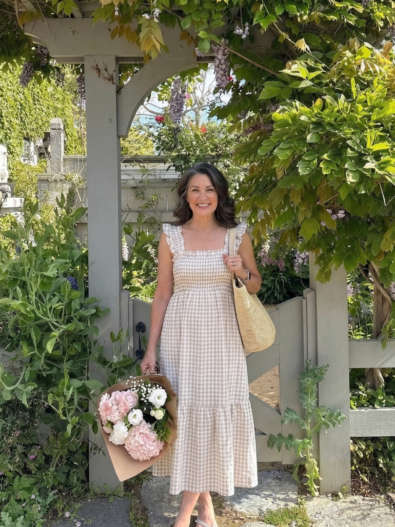Elegant women's gingham maxi dress with flutter sleeves and smocked bodice, ideal for stylish summer comfort.