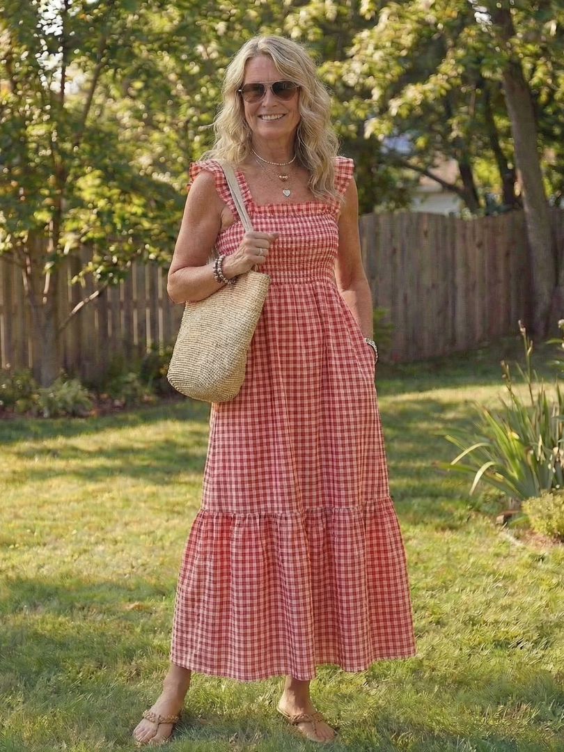 Classic gingham pattern maxi dress for women, featuring a smocked bodice, tiered skirt, and chic flutter sleeves.