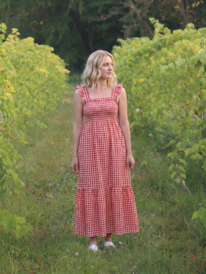 Relaxed fit women's smocked maxi dress with a square neckline, flutter sleeves, and a breezy tiered gingham skirt.