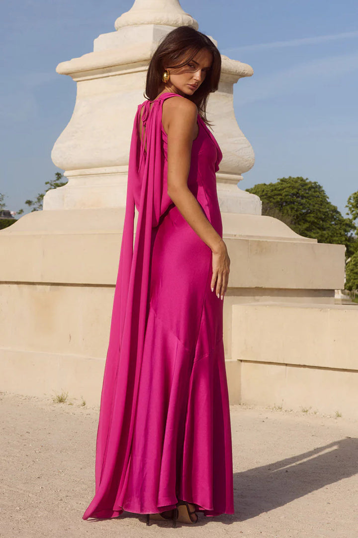 Glamorous fuchsia open-back cowl neck maxi dress, perfect as a wedding guest dress or evening gown.