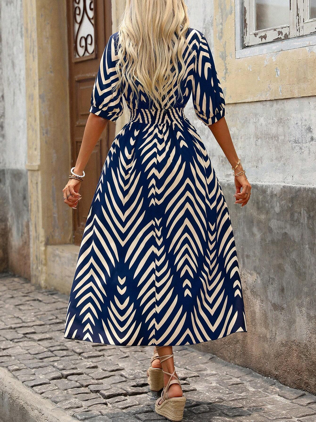 Relaxed fit women's boho dress featuring a vibrant geometric print, ideal for casual day-to-night wear.