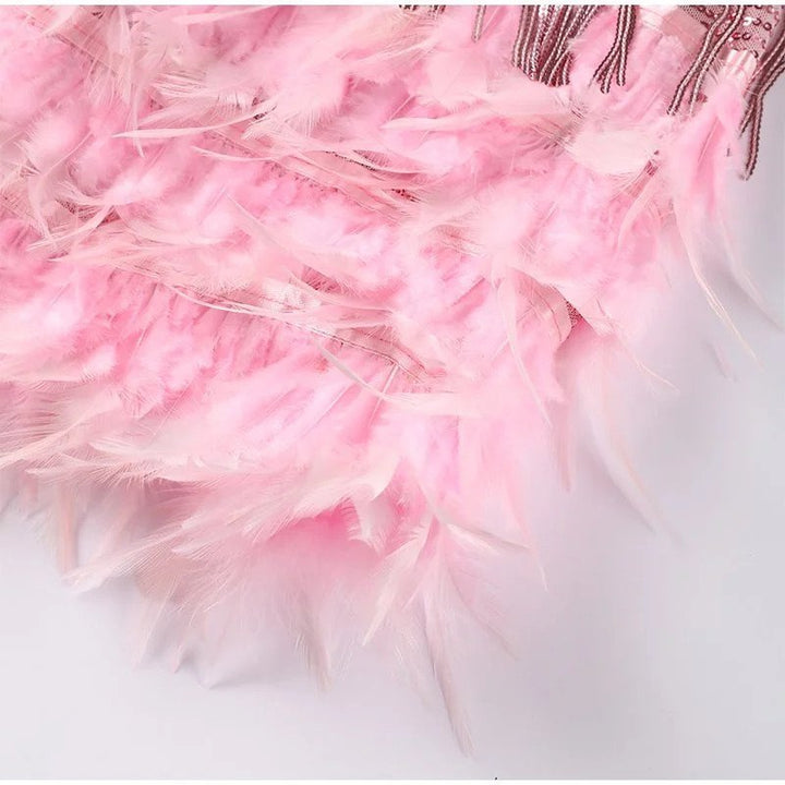 Women's sparkling sequin cocktail dress with flowy fringe, front view.