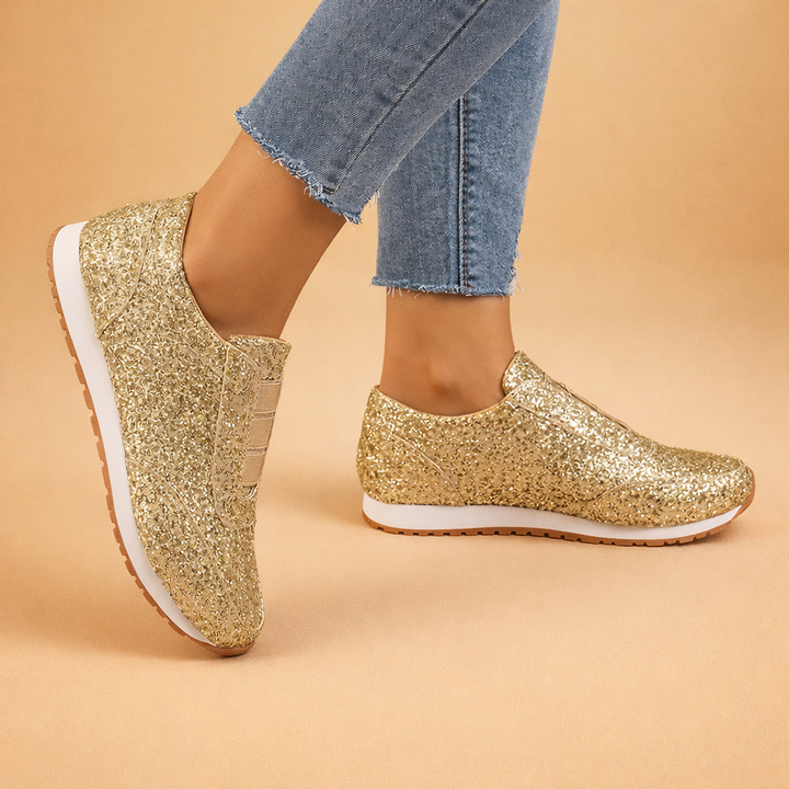 Fashionable womens sneakers featuring a sparkling glitter design and easy slip-on style.