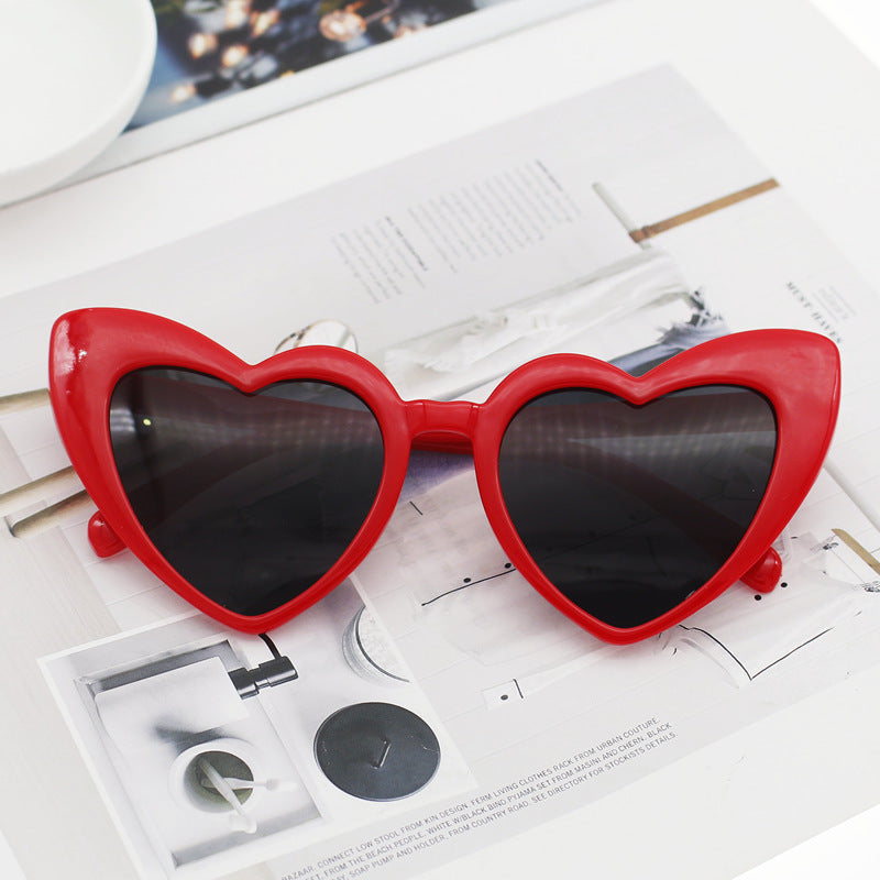 Glamorous women's heart sunglasses, adorned with glitter. Stylish eyewear accessory offering full UV protection.