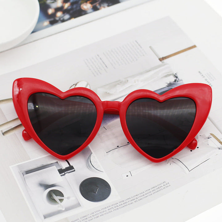 Glamorous women's heart sunglasses, adorned with glitter. Stylish eyewear accessory offering full UV protection.