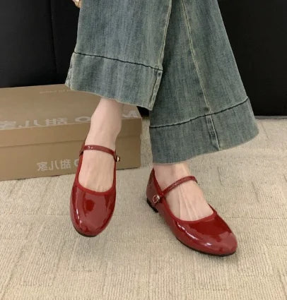 Stylish women's glossy Mary Jane shoes with a comfortable low block heel. Perfect for a polished casual or dressy look.