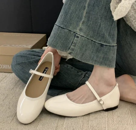 Elegant women's glossy finish Mary Jane shoes featuring a sturdy low block heel. Versatile classic footwear for any occasion.