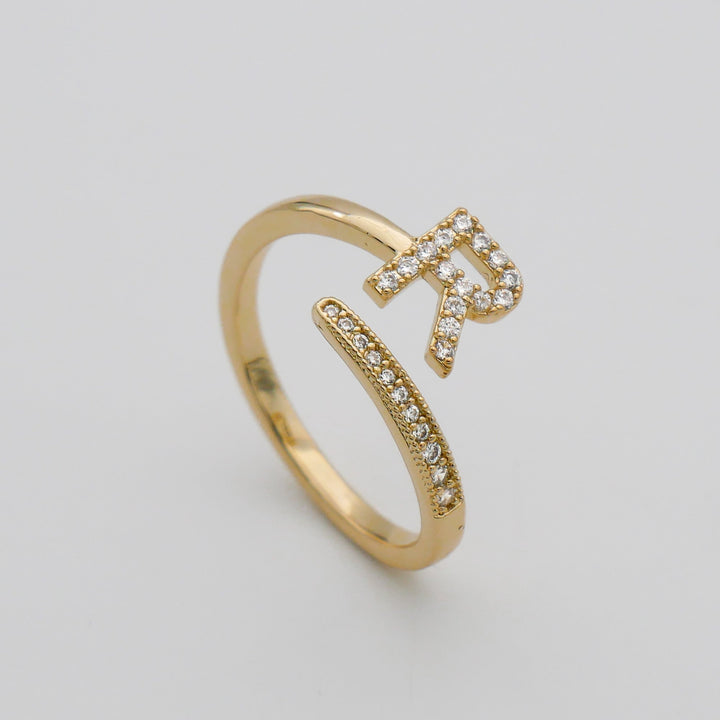 Silver plated adjustable initial ring, pave embellished, for everyday elegance.