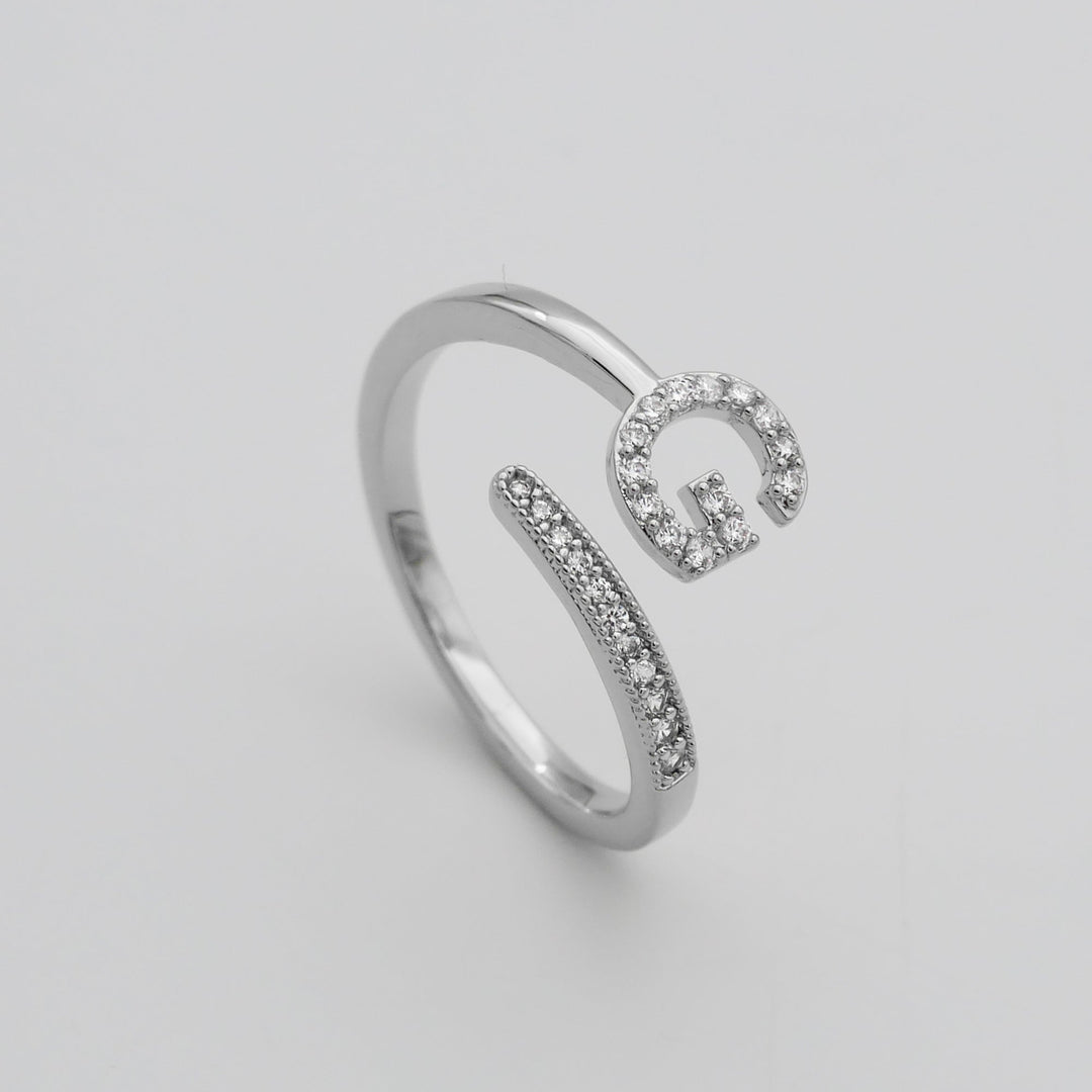Silver plated adjustable women's ring with a custom pave initial.