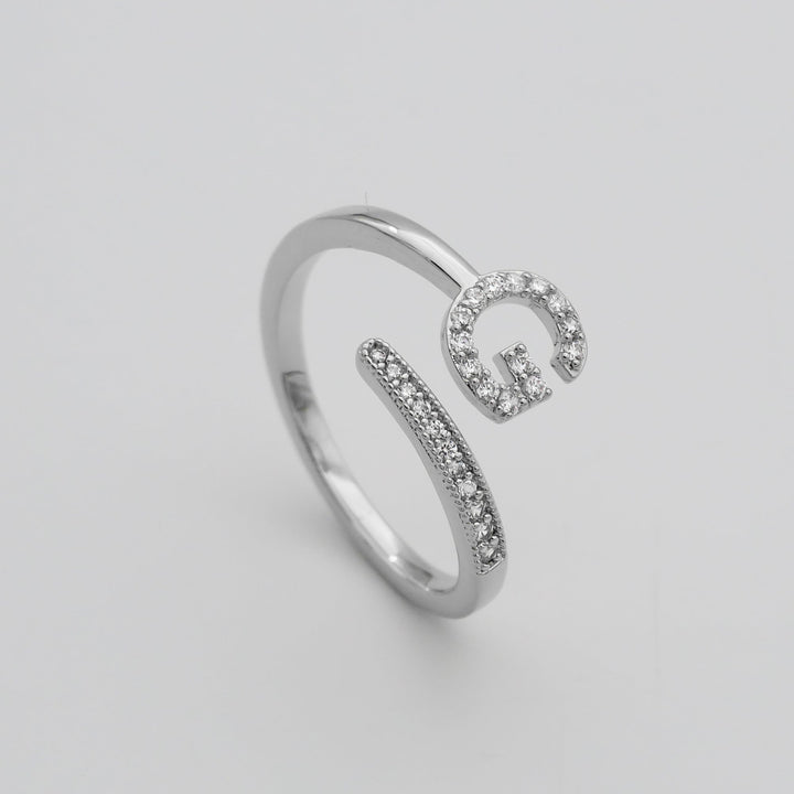 Silver plated adjustable women's ring with a custom pave initial.