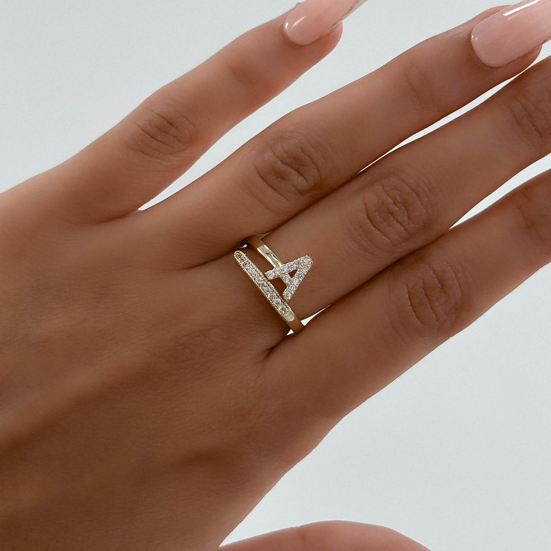 Custom letter adjustable ring, gold tone, with shimmering pave embellishments.