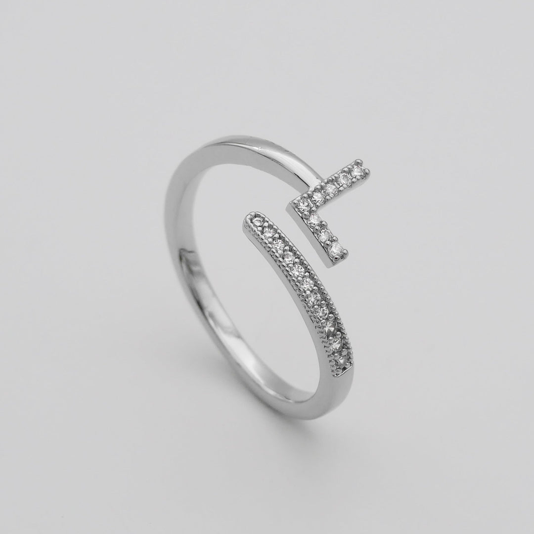 Gold tone adjustable ring with a glittering pave initial, women's statement piece.