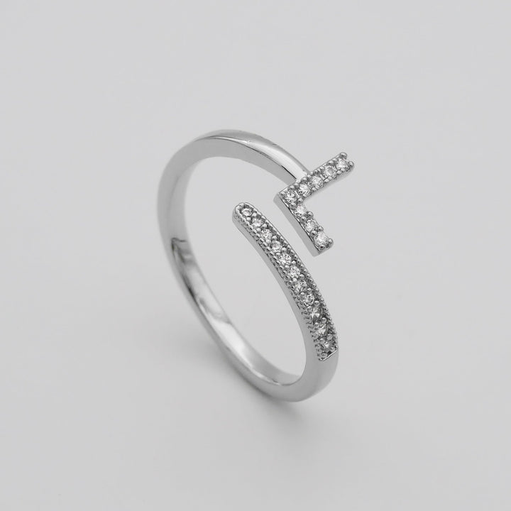 Gold tone adjustable ring with a glittering pave initial, women's statement piece.