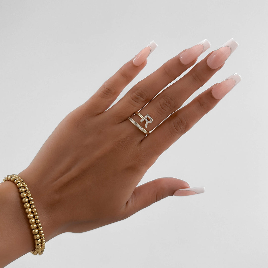 Elegant silver tone adjustable ring featuring a pave initial, women's jewelry.