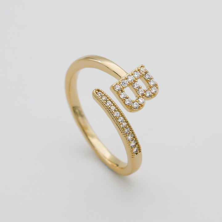 Gold plated statement ring with a dazzling pave initial, adjustable fit.