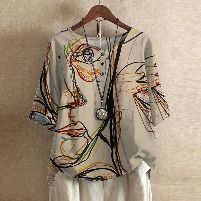 Women's graphic print top. Crew neck, curved hem, medium sleeves. Comfortable & fashionable blouse.
