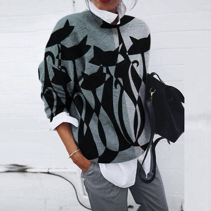 Trendy women's graphic print crew neck sweatshirt. Casual long sleeve, relaxed fit for everyday fall/winter fashion.
