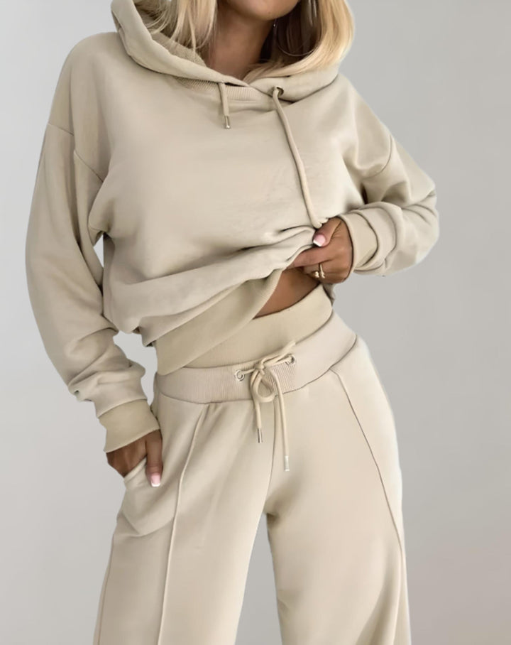 Model wearing a relaxed women's cropped hoodie & wide leg trouser loungewear set, ideal for casual everyday fashion.
