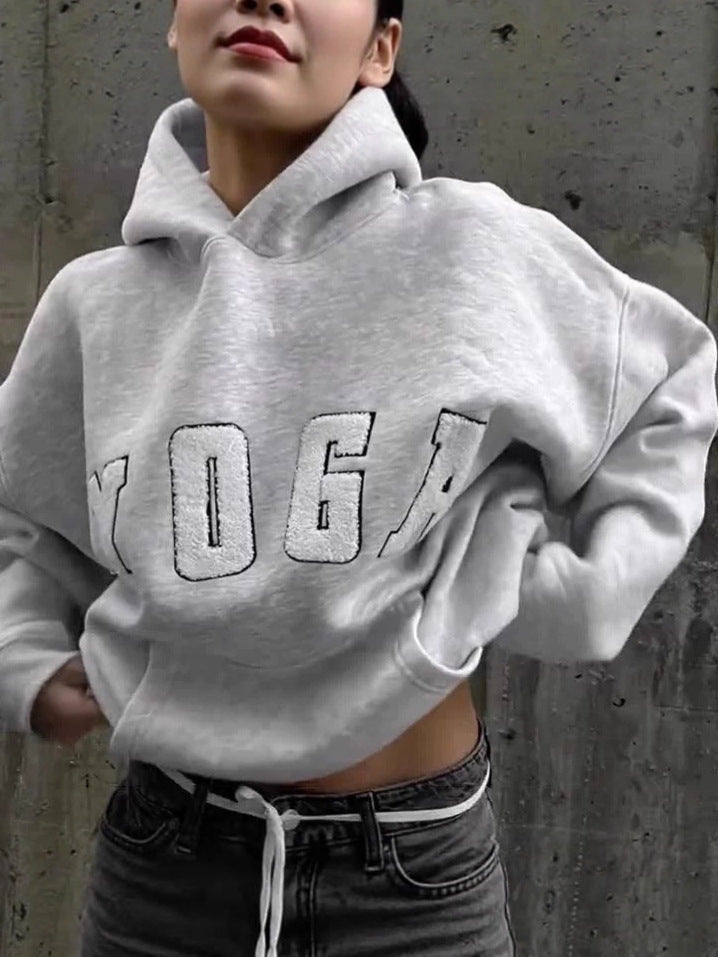 Women's gray yoga hoodie with trendy print, offering a comfortable fit for athleisure wear.
