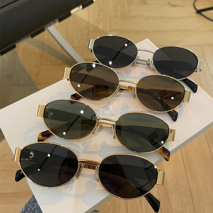 Women's green oval designer sunglasses with UV protection, stylish fashion accessory.