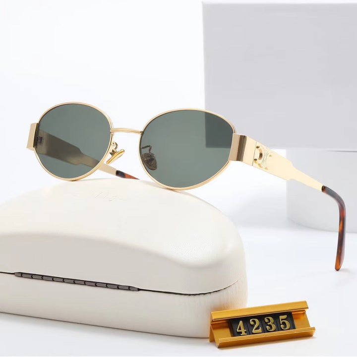 Elegant gold oval frame women's sunglasses, a stylish UV protective designer accessory.