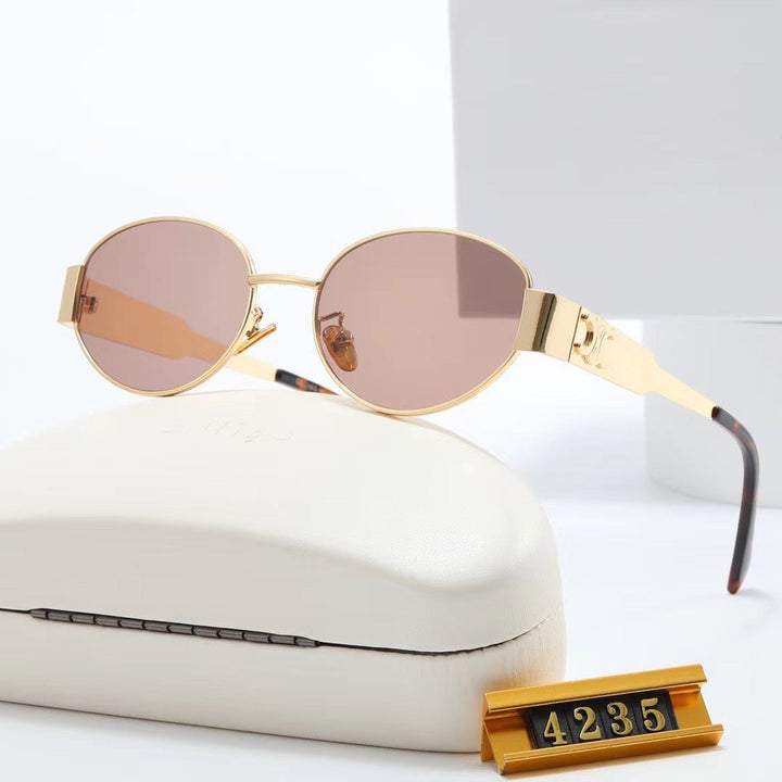 High-fashion silver oval women's sunglasses, premium designer eyewear with UV protection.