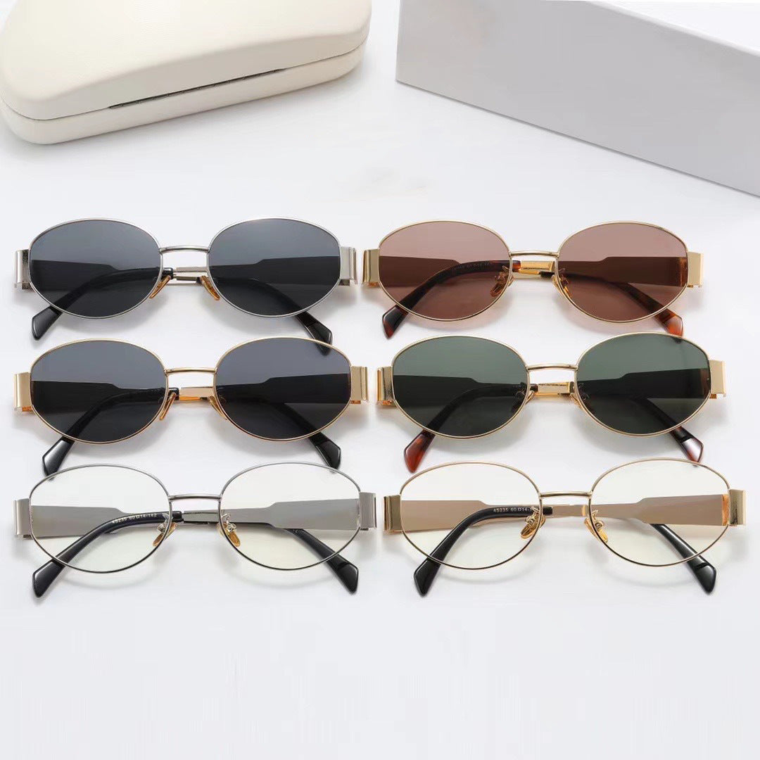 Chic gold frame oval women's sunglasses, a designer fashion accessory offering UV protection.
