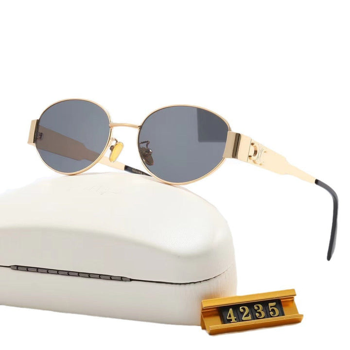 Close-up: Women's green oval designer sunglasses, highlighting stylish frames & UV protection.