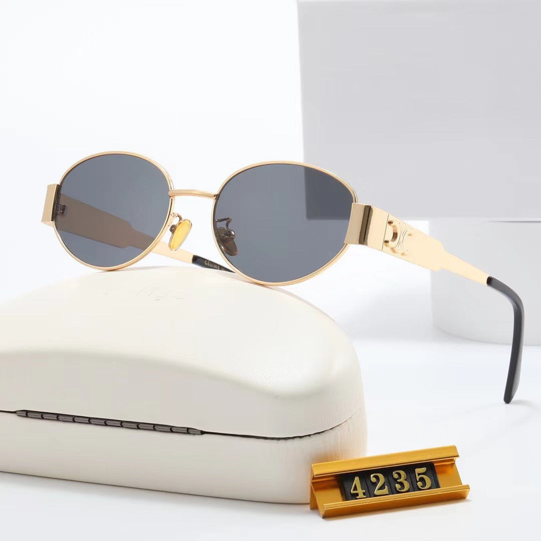 Side view: Chic gold oval women's sunglasses, a fashionable designer accessory.