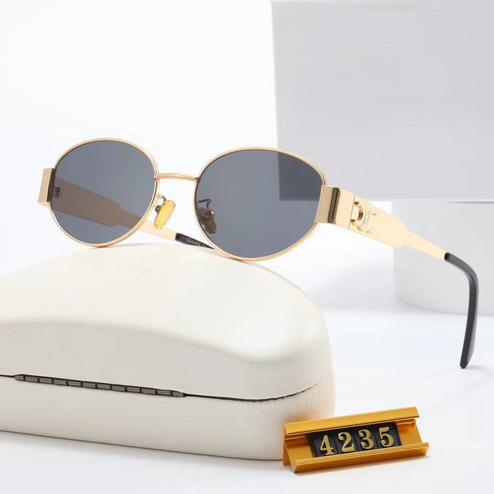 Side view: Chic gold oval women's sunglasses, a fashionable designer accessory.