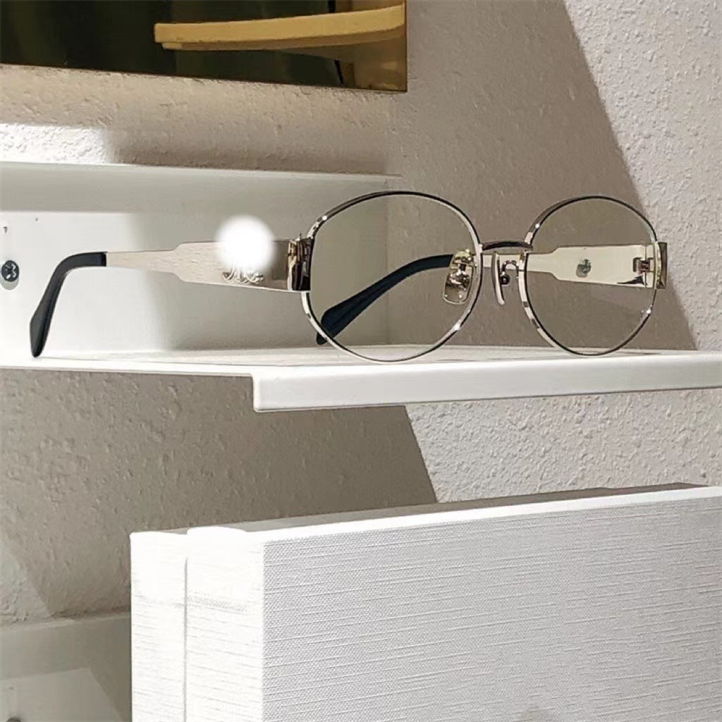 Sophisticated silver oval women's sunglasses, designer eyewear for stylish UV protection.
