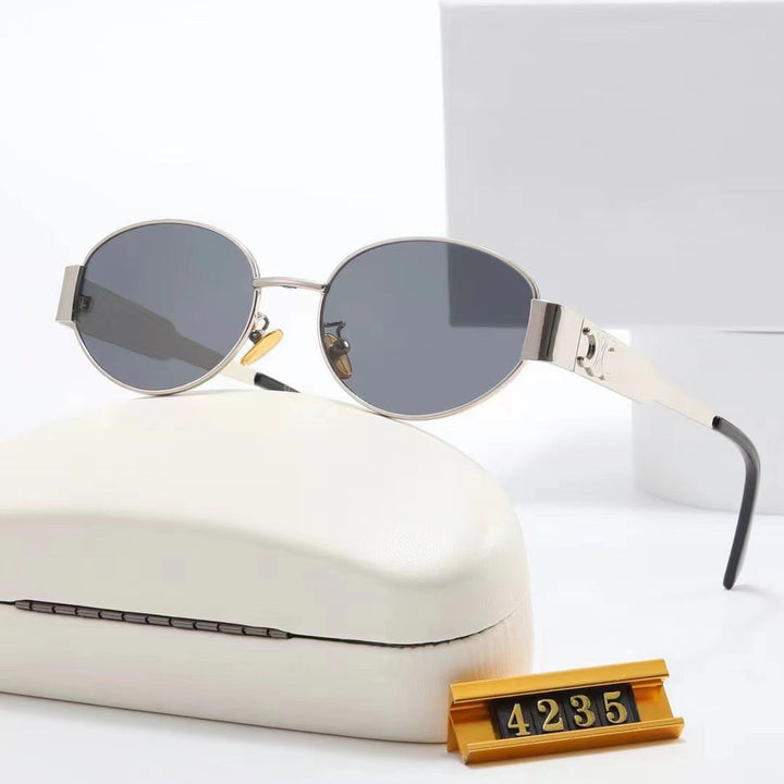Fashionable green oval designer sunglasses for women, offering UV protection & stylish look.