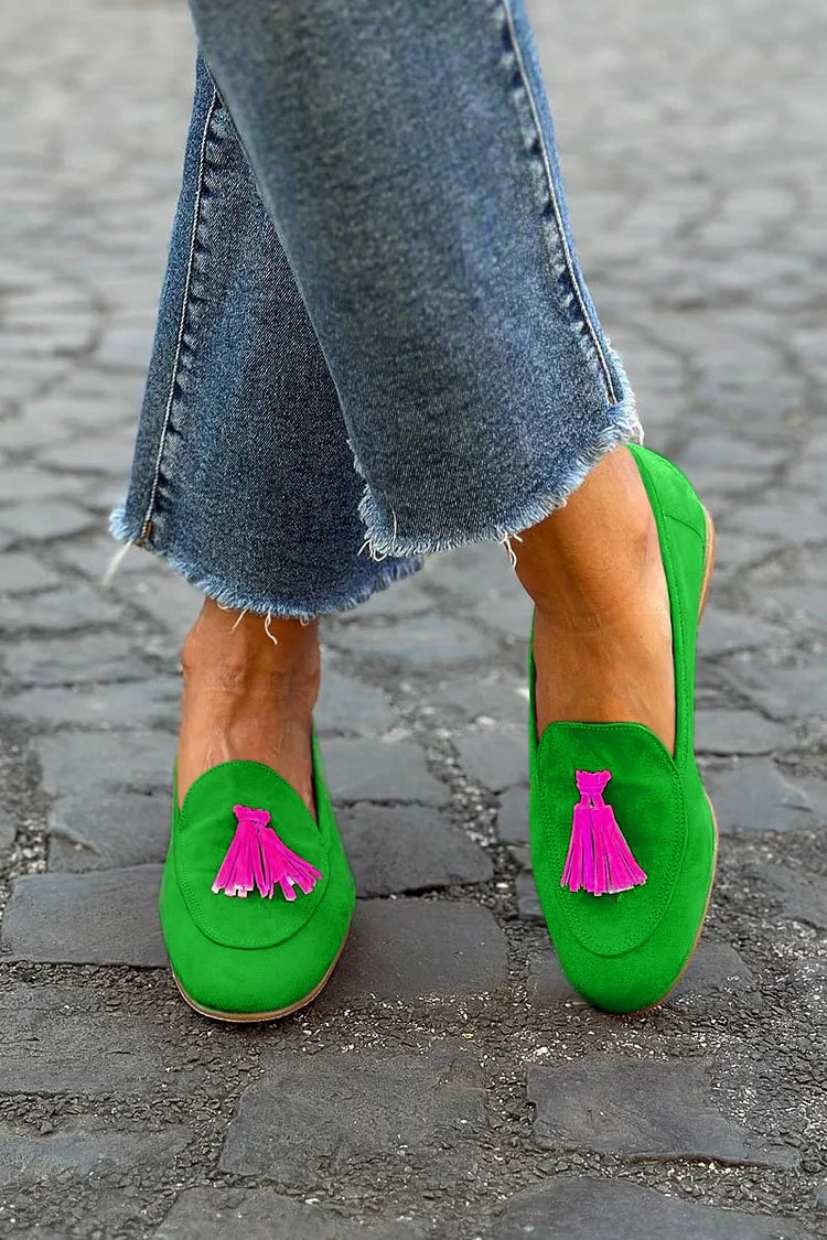 Women's green tassel loafers, comfortable slip-on flat shoes for casual everyday wear. Stylish fashion footwear.