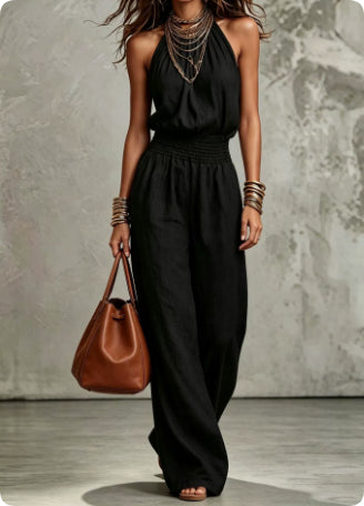 Relaxed fit women's halter neck wide-leg jumpsuit, backless & smocked waist, offering breezy summer holiday style.