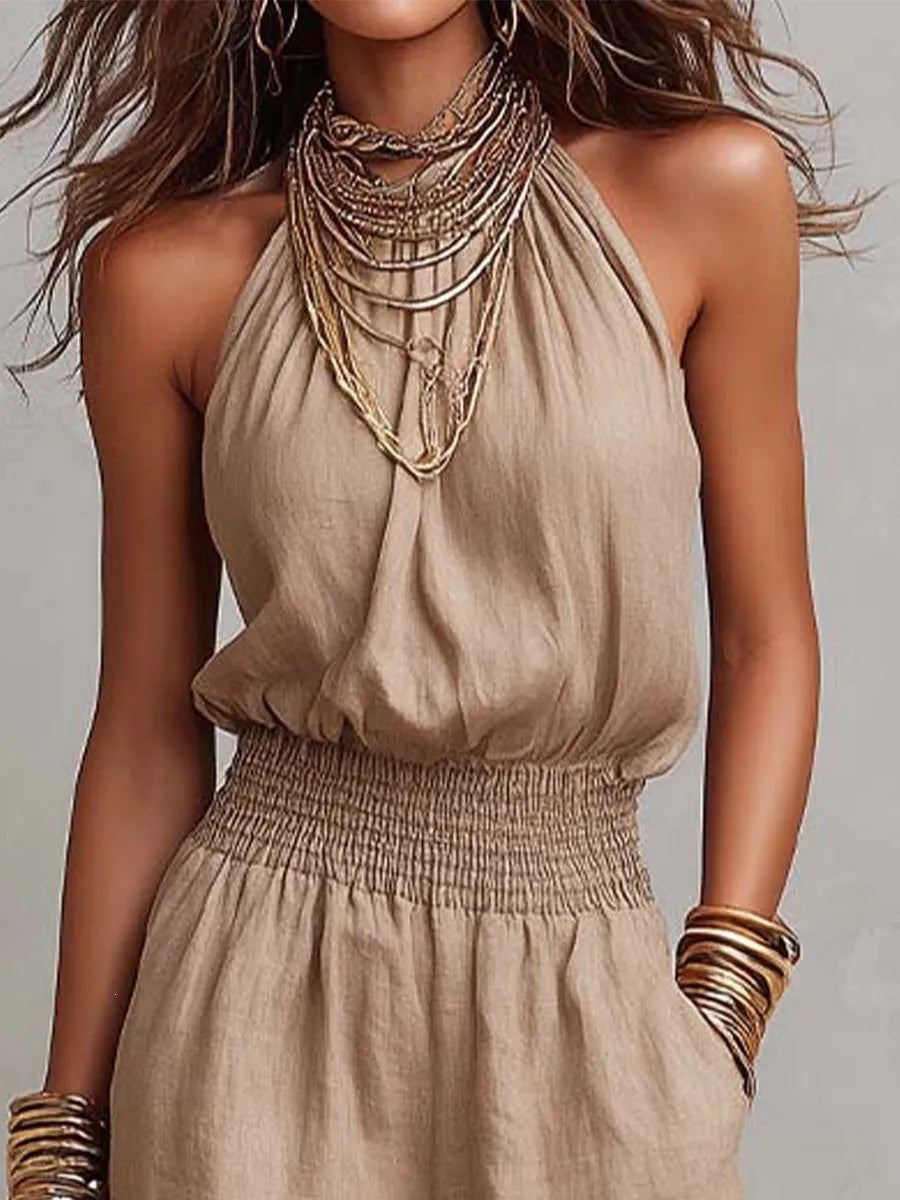 Comfortable women's backless wide-leg jumpsuit with halter neck & smocked waist. Ideal for casual summer fashion.