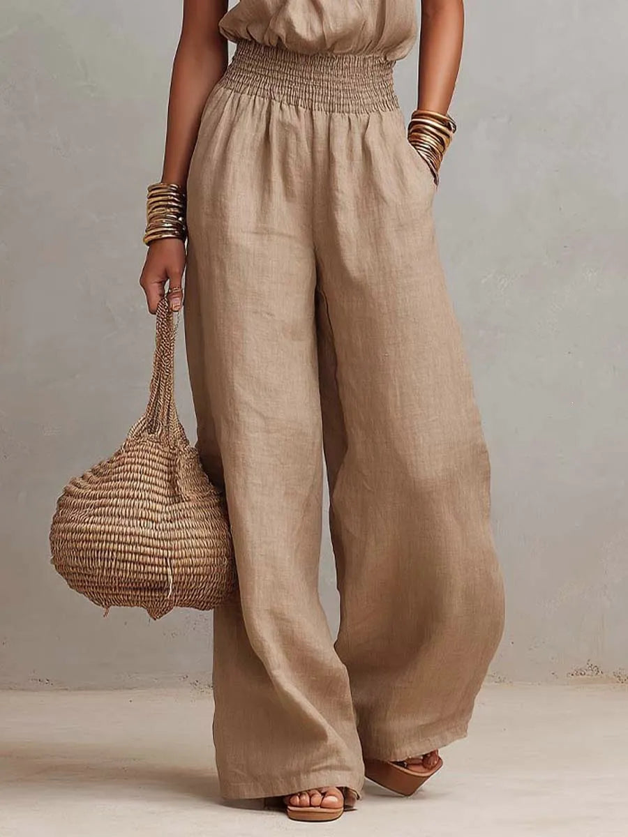 Versatile women's halter neck jumpsuit, backless & wide-leg with smocked waist. Great for holidays or chic casual wear.