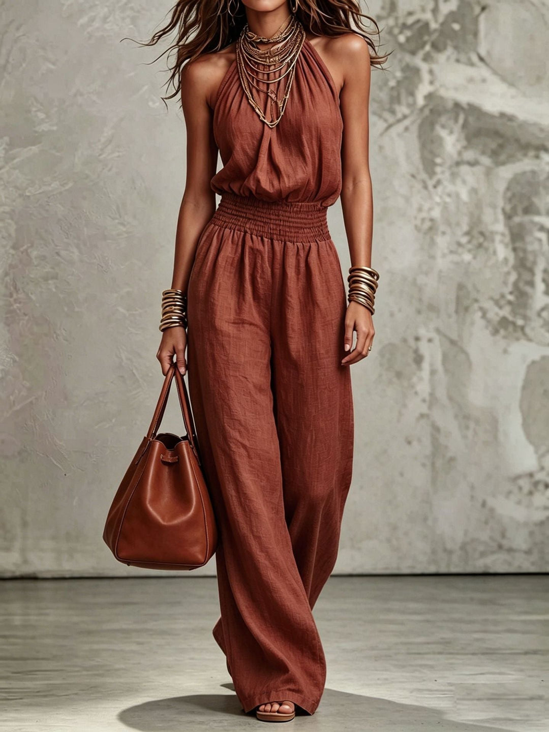 Full length women's wide-leg jumpsuit, halter neck, backless design, and elastic smocked waist for casual elegance.