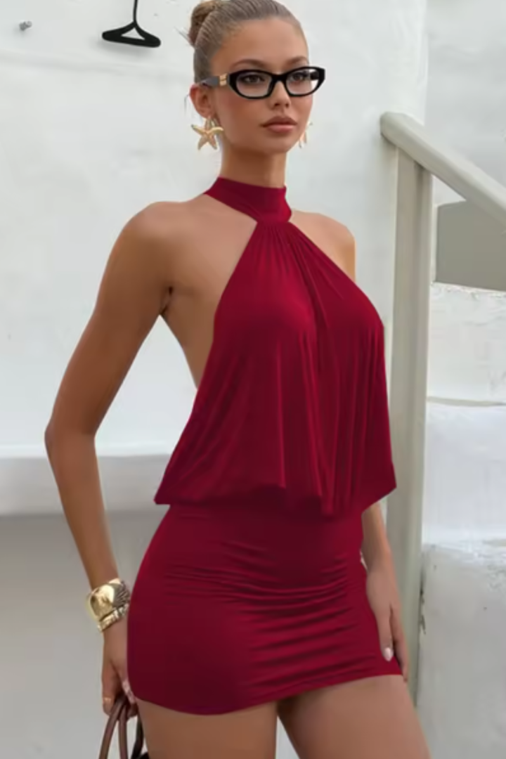 Sophisticated women's elegant mini dress. Halter neck, ruched detailing, & backless cut for memorable evening events.