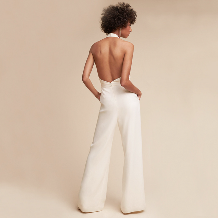 Essential women's wide-leg jumpsuit with halter neck & deep V, offering chic apparel & comfortable style.