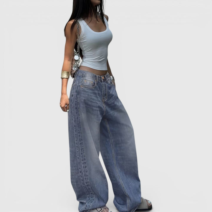 Baggy women's denim jeans, oversized and straight leg, offering a modern casual look.